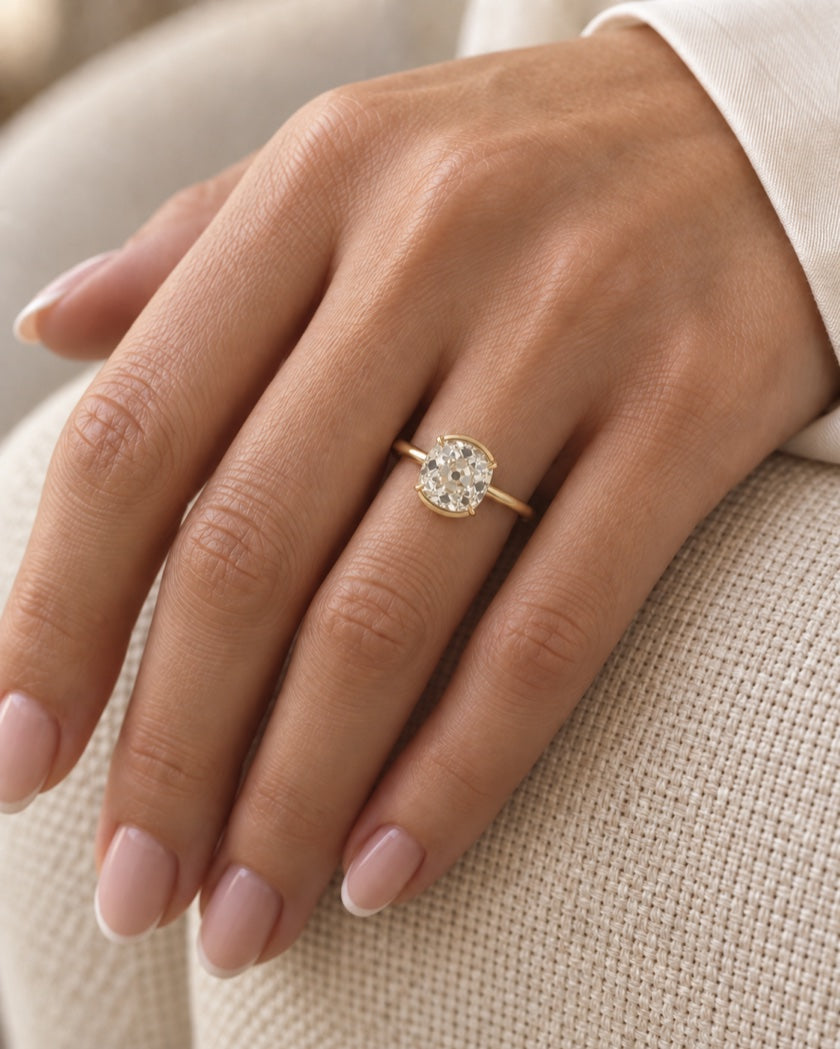 Old mine cut lab-grown diamond engagement ring in yellow gold worn on the hand | Sula Bridal — Editorial